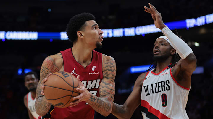 Jan 21, 2025; Miami, Florida, USA; Miami Heat center Kel'el Ware (7) drives to the basket against Portland Trail Blazers forward Jerami Grant (9) during the second quarter at Kaseya Center. Mandatory Credit: Sam Navarro-Imagn Images