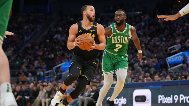 Jan 20, 2025; San Francisco, California, USA; Golden State Warriors guard Stephen Curry (30) drives past Boston Celtics forward Jaylen Brown (7) in the third quarter at the Chase Center. Mandatory Credit: Cary Edmondson-Imagn Images