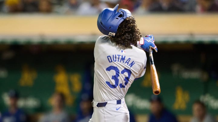 Aug 2, 2024; Oakland, California, USA; The batting helmet of Los Angeles Dodgers outfielder James Outman (33) covers his face while swinging during an at bat against the Oakland Athletics during the seventh inning at Oakland-Alameda County Coliseum. Mandatory Credit: Robert Edwards-Imagn Images