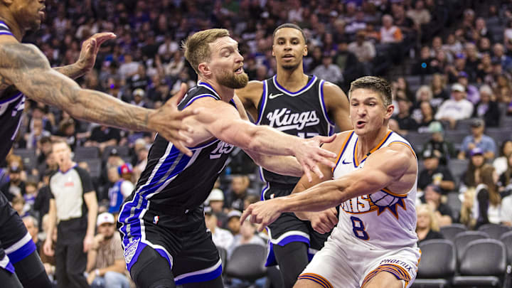Phoenix Suns guard Grayson Allen passes as Sacramento Kings center Domantas Sabonis defends. Phoenix Suns guard Grayson Allen passes as Sacramento Kings center Domantas Sabonis defends.