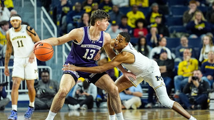 Michigan guard Nimari Burnett (4) tries to steal the ball from Northwestern guard Brooks Barnhizer (13) during the first half at Crisler Center in Ann Arbor on Sunday, Jan. 19, 2025. Michigan guard Nimari Burnett (4) tries to steal the ball from Northwestern guard Brooks Barnhizer (13) during the first half at Crisler Center in Ann Arbor on Sunday, Jan. 19, 2025.