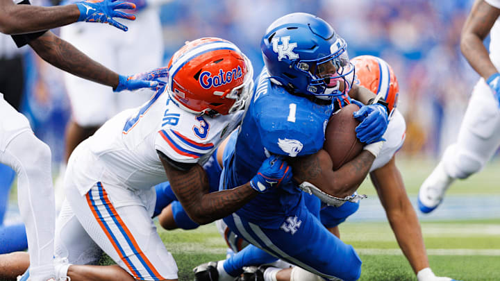 Sep 30, 2023; Lexington, Kentucky, USA; Kentucky Wildcats running back Ray Davis (1) is brought down by Florida Gators cornerback Jason Marshall Jr. (3) during the fourth quarter at Kroger Field. Mandatory Credit: Jordan Prather-Imagn Images