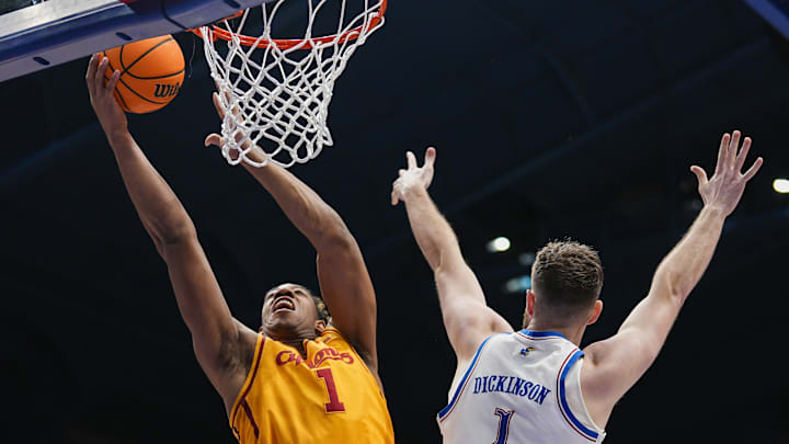 Feb 3, 2025; Lawrence, Kansas, USA; Iowa State Cyclones center Dishon Jackson (1) shoots against Kansas Jayhawks center Hunter Dickinson (1) during the first half at Allen Fieldhouse. Mandatory Credit: Jay Biggerstaff-Imagn Images