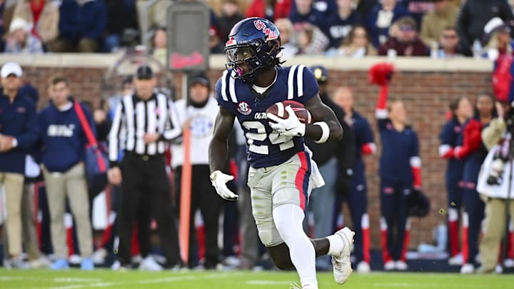 Nov 29, 2024; Oxford, Mississippi, USA; Mississippi Rebels running back Ulysses Bentley IV (24) runs the ball against the Mississippi State Bulldogs during a play that would result in a touchdown during the second quarter at Vaught-Hemingway Stadium. Mandatory Credit: Matt Bush-Imagn Images