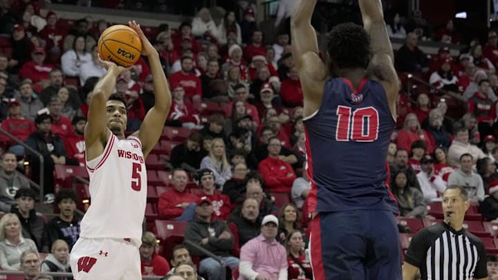Wisconsin guard Daniel Freitag (5) shoots over Detroit Mercy guard Nate Johnson (10) during the second half of their game Sunday, December 22, 2024 at the Kohl Center in Madison, Wisconsin. Wisconsin beat Detroit Mercy 76-53.