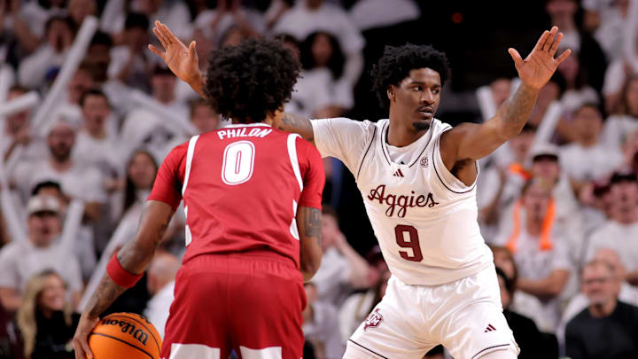 Jan 11, 2025; College Station, Texas, USA; Texas A&M Aggies forward Solomon Washington (9) defends against Alabama Crimson Tide guard Labaron Philon (0) during the first half at Reed Arena. Mandatory Credit: Erik Williams-Imagn Images