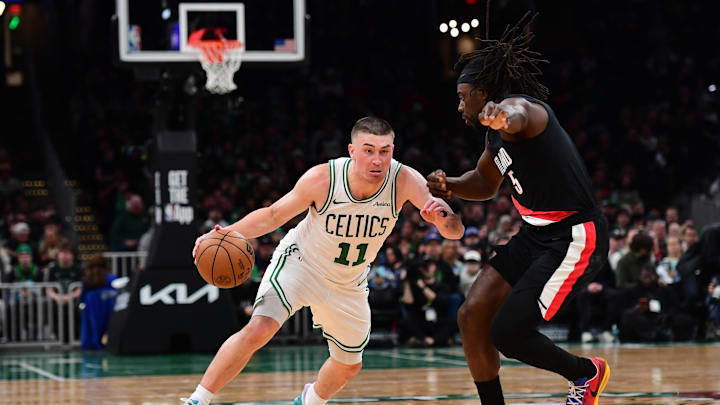 Jan 26, 2026; Boston, Massachusetts, USA; Boston Celtics guard Payton Pritchard (11) controls the ball while Portland Trail Blazers guard Jrue Holiday (5) defends during the second half at TD Garden. Mandatory Credit: Bob DeChiara-Imagn Images