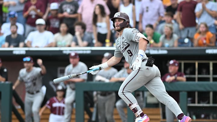 Jun 24, 2024; Omaha, NE, USA;  Texas A&M Aggies third baseman Gavin Grahovac (9) drives in a run with a sacrifice fly against the Tennessee Volunteers during the third inning at Charles Schwab Field Omaha. Mandatory Credit: Steven Branscombe-Imagn Images