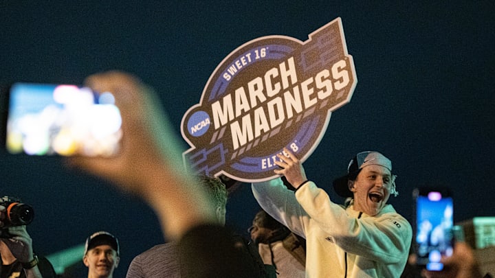 Purdue Boilermakers guard Fletcher Loyer holds up a March Madness sign to the crowd last season.