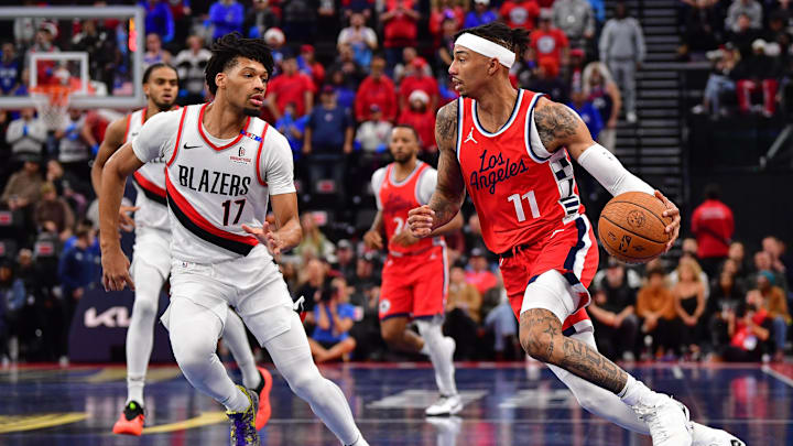 Dec 3, 2024; Inglewood, California, USA; Los Angeles Clippers guard Jordan Miller (11) moves the ball against Portland Trail Blazers guard Shaedon Sharpe (17) during the first half at Intuit Dome. Mandatory Credit: Gary A. Vasquez-Imagn Images