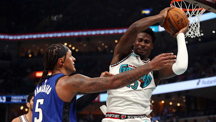 Oct 26, 2024; Memphis, Tennessee, USA; Memphis Grizzlies forward Jaren Jackson Jr. (13) collects a rebound over Orlando Magic forward Paolo Banchero (5) during the first half at FedExForum. Mandatory Credit: Petre Thomas-Imagn Images