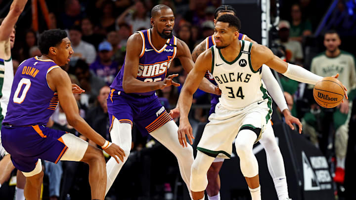 Mar 24, 2025; Phoenix, Arizona, USA; Milwaukee Bucks forward Giannis Antetokounmpo (34) handles the ball against Phoenix Suns forward Kevin Durant (35) during the second quarter at Footprint Center. Mandatory Credit: Mark J. Rebilas-Imagn Images