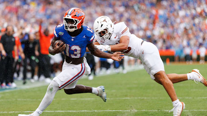 Oct 4, 2025; Gainesville, Florida, USA; Florida Gators running back Jadan Baugh (13) breaks a tackle from Texas Longhorns linebacker Liona Lefau (18) during the first half at Ben Hill Griffin Stadium. Mandatory Credit: Matt Pendleton-Imagn Images