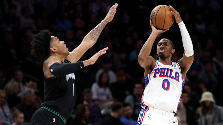 Feb 22, 2026; Minneapolis, Minnesota, USA; Philadelphia 76ers guard Tyrese Maxey (0) shoots over Minnesota Timberwolves guard Terrence Shannon Jr. (1) during the first half at Target Center. Mandatory Credit: Matt Krohn-Imagn Images