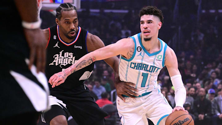 Charlotte Hornets guard LaMelo Ball (1) dribbles the ball while defended by Los Angeles Clippers forward Kawhi Leonard (2) during the first quarter at Crypto.com Arena. Mandatory Credit: Richard Mackson-Imagn Images