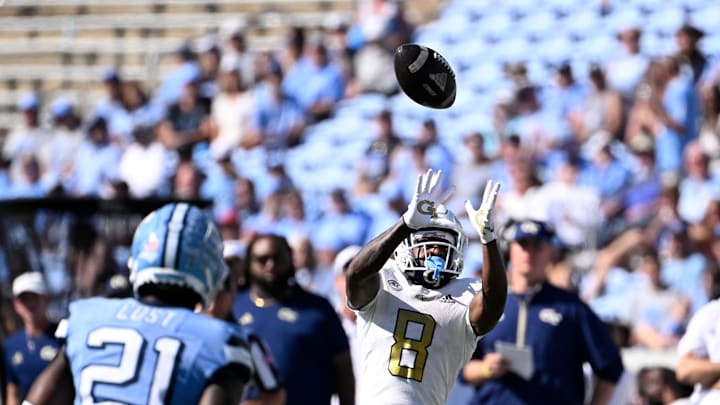 Oct 12, 2024; Chapel Hill, North Carolina, USA; Georgia Tech Yellow Jackets wide receiver Malik Rutherford (8) catches the ball as North Carolina Tar Heels defensive back Kaleb Cost (21) defends in the third quarter at Kenan Memorial Stadium. Mandatory Credit: Bob Donnan-Imagn Images