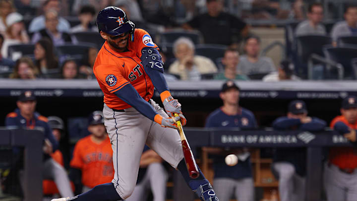 Aug 8, 2025; Bronx, New York, USA; Houston Astros shortstop Carlos Correa (1) hits an RBI single during the tenth inning against the New York Yankees at Yankee Stadium. 