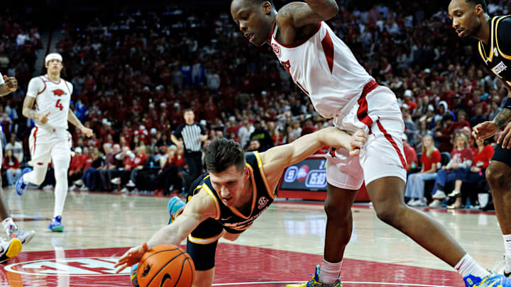 Arkansas senior guard Johnell Davis forces Missouri Caleb Grill into a turnover during Saturday's 92-85 Razorback victory at Bud Walton Arena