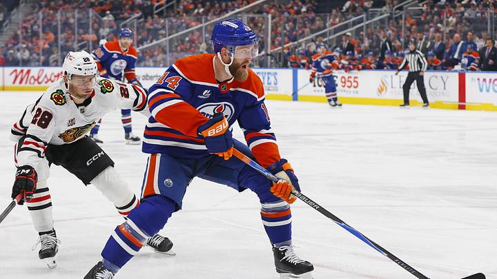 Apr 2, 2026; Edmonton, Alberta, CAN; Edmonton Oilers defensemen Mattias Ekholm (14) carries the puck in front of Chicago Blackhawks forward Andre Burakovsky (28) during the second period at Rogers Place. Mandatory Credit: Perry Nelson-Imagn Images Apr 2, 2026; Edmonton, Alberta, CAN; Edmonton Oilers defensemen Mattias Ekholm (14) carries the puck in front of Chicago Blackhawks forward Andre Burakovsky (28) during the second period at Rogers Place. Mandatory Credit: Perry Nelson-Imagn Images