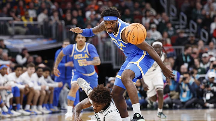 Mar 13, 2026; Chicago, IL, USA; UCLA Bruins forward Eric Dailey Jr. (3) battles for the ball with Michigan State Spartans forward Jesse McCulloch (35) during the first half at United Center. Mandatory Credit: Kamil Krzaczynski-Imagn Images