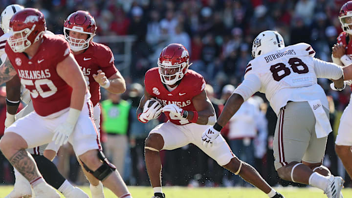 Nov 1, 2025; Fayetteville, Arkansas, USA; Arkansas Razorbacks running back Mike Washington Jr (4) rushes during the first quarter against the Mississippi State Bulldogs at Donald W. Reynolds Razorback Stadium. Mandatory Credit: Nelson Chenault-Imagn Images