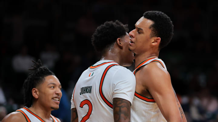 Dec 3, 2024; Coral Gables, Florida, USA; Miami Hurricanes forward Brandon Johnson (2) celebrates with center Lynn Kidd (1) after scoring against the Arkansas Razorbacks during the second half at Watsco Center. Mandatory Credit: Sam Navarro-Imagn Images