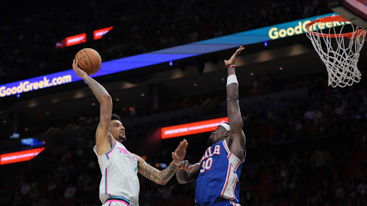 Apr 7, 2025; Miami, Florida, USA; Miami Heat center Kel'el Ware (7) shoots the basketball over Philadelphia 76ers center Adem Bona (30) during the second quarter at Kaseya Center. Mandatory Credit: Sam Navarro-Imagn Images