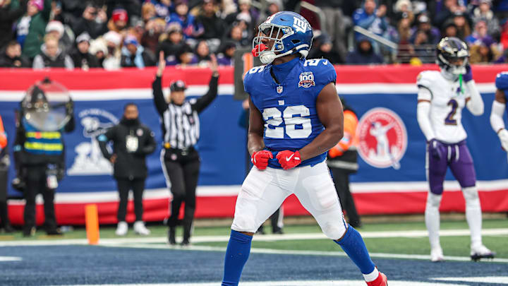 Dec 15, 2024; East Rutherford, New Jersey, USA; New York Giants running back Devin Singletary (26) celebrates after his rushing touchdown against the Baltimore Ravens at MetLife Stadium in the first half. Dec 15, 2024; East Rutherford, New Jersey, USA; New York Giants running back Devin Singletary (26) celebrates after his rushing touchdown against the Baltimore Ravens at MetLife Stadium in the first half.