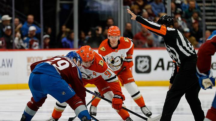 Nov 11, 2025; Denver, Colorado, USA; Colorado Avalanche center Nathan MacKinnon (29) faces off against Anaheim Ducks center Leo Carlsson (91) on a puck drop from referee Jean Hebert (15) in the first period at Ball Arena. Mandatory Credit: Isaiah J. Downing-Imagn Images