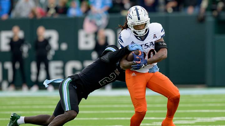Nov 24, 2023; New Orleans, Louisiana, USA; UTSA Roadrunners running back Robert Henry (20) runs against Tulane linebacker Dorian Williams (2) during the first half at Yulman Stadium. Mandatory Credit: Matthew Hinton-USA TODAY Sports Nov 24, 2023; New Orleans, Louisiana, USA; UTSA Roadrunners running back Robert Henry (20) runs against Tulane linebacker Dorian Williams (2) during the first half at Yulman Stadium. Mandatory Credit: Matthew Hinton-USA TODAY Sports