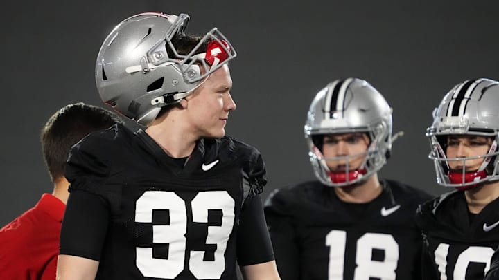 Mar 7, 2024; Columbus, OH, USA; Ohio State Buckeyes quarterback Devin Brown (33) walks with quarterbacks Will Howard (18) and Julian Sayin (10) during spring football practice at the Woody Hayes Athletic Center.