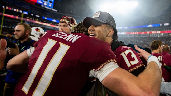 Florida State Seminoles quarterback Jordan Travis (13) hugs Florida State Seminoles quarterback Brock Glenn (11) as the team celebrates defeating the Louisville Cardinals 16-6 to claim the ACC Championship title in Charlotte, North Carolina on Saturday, Dec. 2, 2023.