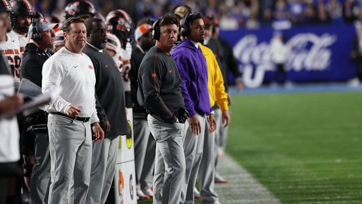 Oct 18, 2024; Provo, Utah, USA; Oklahoma State Cowboys head coach Mike Gundy (center) looks on against the Brigham Young Cougars during the second quarter at LaVell Edwards Stadium. Mandatory Credit: Rob Gray-Imagn Images