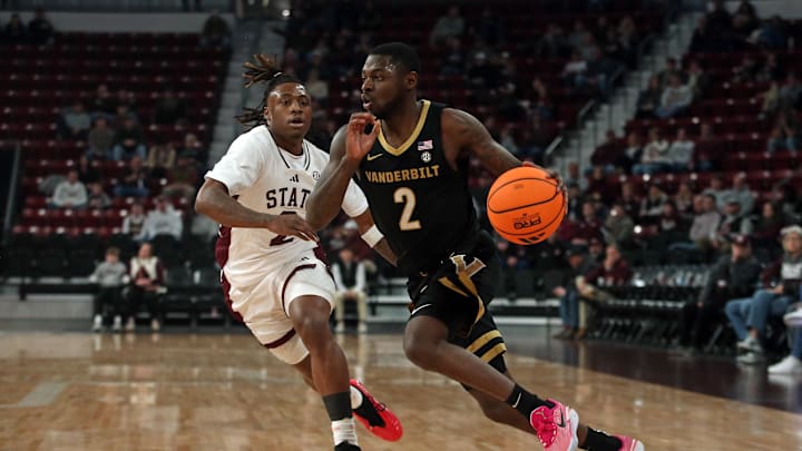 Jan 24, 2026; Starkville, Mississippi, USA; Vanderbilt Commodores guard Duke Miles (2) drives to the basket as Mississippi State Bulldogs guard Ja’Borri McGhee (2) defends during the first half at Humphrey Coliseum. Mandatory Credit: Petre Thomas-Imagn Images