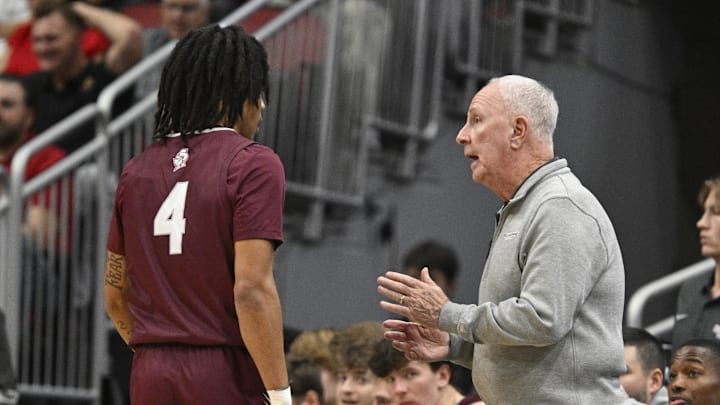 Nov 19, 2024; Louisville, Kentucky, USA;  Bellarmine Knights head coach Scott Davenport talks with guard Dezmond McKinney (4) during the first half against the Louisville Cardinals at KFC Yum! Center. Mandatory Credit: Jamie Rhodes-Imagn Images