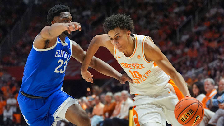 Tennessee forward Nate Ament (10) dribbles past Kentucky forward Mouhamed Dioubate (23).