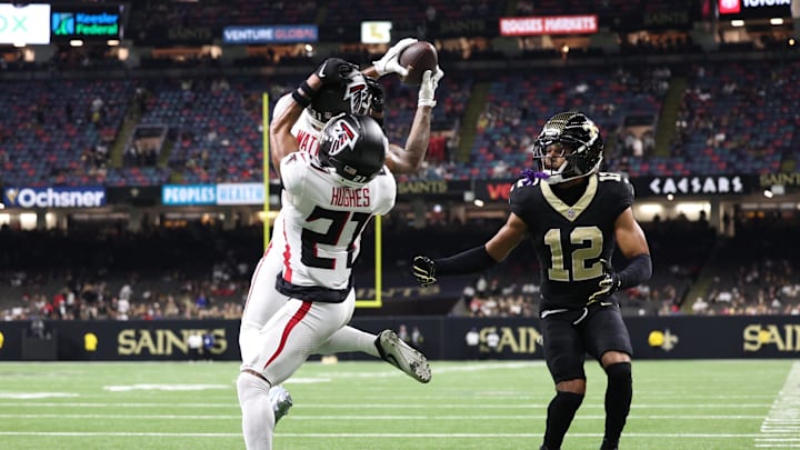 Nov 23, 2025; New Orleans, Louisiana, USA; Atlanta Falcons safety Xavier Watts (31) makes the interception in front of teammate cornerback Mike Hughes (21) and New Orleans Saints wide receiver Chris Olave (12) during the second half at Caesars Superdome. Mandatory Credit: Stephen Lew-Imagn Images