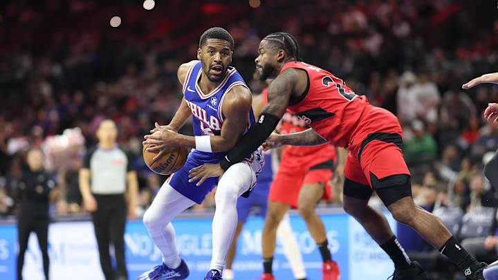 Mar 30, 2025; Philadelphia, Pennsylvania, USA; Philadelphia 76ers guard Jared Butler (12) controls the ball against Toronto Raptors guard Jamal Shead (23) during the first quarter at Wells Fargo Center. Mandatory Credit: Bill Streicher-Imagn Images Mar 30, 2025; Philadelphia, Pennsylvania, USA; Philadelphia 76ers guard Jared Butler (12) controls the ball against Toronto Raptors guard Jamal Shead (23) during the first quarter at Wells Fargo Center. Mandatory Credit: Bill Streicher-Imagn Images
