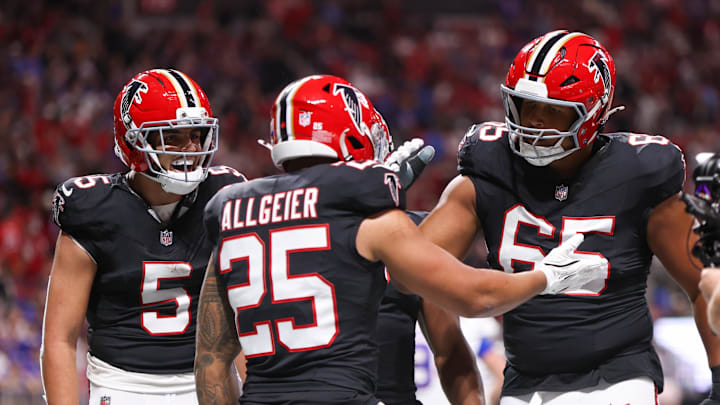 Atlanta Falcons running back Tyler Allgeier reacts with guard Matthew Bergeron 
