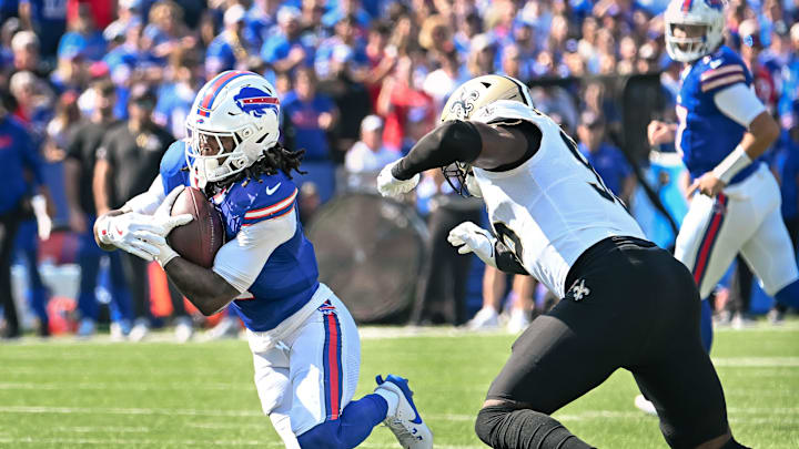 Sep 28, 2025; Orchard Park, New York, USA; Buffalo Bills running back James Cook (4) runs past New Orleans Saints defensive end Carl Granderson (96) in the first quarter at Highmark Stadium. Mandatory Credit: Mark Konezny-Imagn Images Sep 28, 2025; Orchard Park, New York, USA; Buffalo Bills running back James Cook (4) runs past New Orleans Saints defensive end Carl Granderson (96) in the first quarter at Highmark Stadium. Mandatory Credit: Mark Konezny-Imagn Images