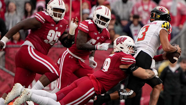 Nov 5, 2022; Madison, Wisconsin, USA; Wisconsin Badgers linebacker Nick Herbig (19) sacks Maryland Terrapins quarterback Taulia Tagovailoa (3) during the third quarter at Camp Randall Stadium.