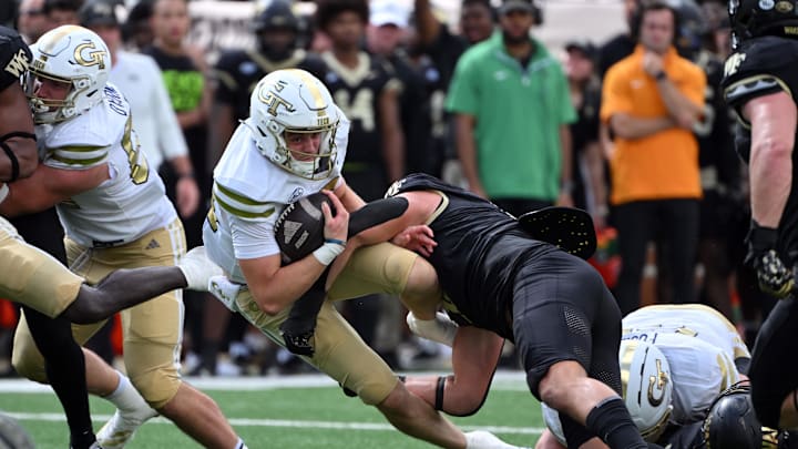 Sep 27, 2025; Winston-Salem, North Carolina, USA; Georgia Tech Yellow Jackets quarterback Haynes King (10) is tackled by Wake Forest Demon Deacons defensive lineman Gabe Kirschke (10) during the fourth quarter at Allegacy Federal Credit Union Stadium. Mandatory Credit: Zachary Taft-Imagn Images Sep 27, 2025; Winston-Salem, North Carolina, USA; Georgia Tech Yellow Jackets quarterback Haynes King (10) is tackled by Wake Forest Demon Deacons defensive lineman Gabe Kirschke (10) during the fourth quarter at Allegacy Federal Credit Union Stadium. Mandatory Credit: Zachary Taft-Imagn Images
