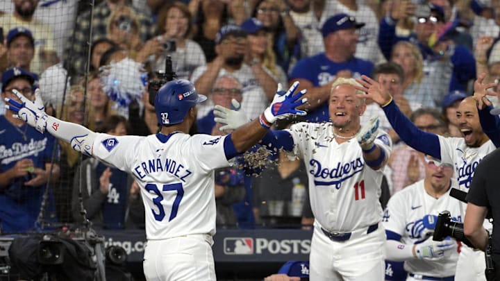 Los Angeles Dodgers outfielder Teoscar Hernandez (37) celebrates with shortstop Miguel Rojas (11) and shortstop Mookie Betts (50) after hitting a solo home run in the seventh inning against the San Diego Padres during game five of the NLDS for the 2024 MLB Playoffs at Dodger Stadium on Oct 11.