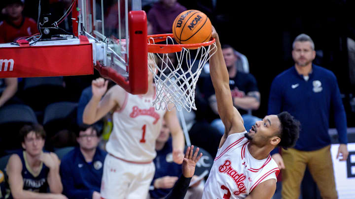 Bradley’s Zek Montgomery (3) dunks the ball over Judson’s Isaiah Perry in the first half of the Braves’ 107-41 blowout of the Eagles on Friday, Nov. 29, 2024 at Carver Arena.