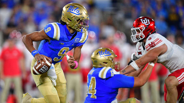 Aug 30, 2025; Pasadena, California, USA; UCLA Bruins quarterback Nico Iamaleava (9) runs the ball as offensive lineman Sam Yoon (64) provides coverage against Utah Utes linebacker Lander Barton (8) during the second half at Rose Bowl. Mandatory Credit: Gary A. Vasquez-Imagn Images