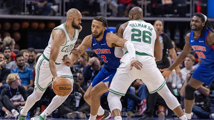 Oct 26, 2024; Detroit, Michigan, USA; Boston Celtics guard Derrick White (9) controls the ball as forward Xavier Tillman (26) picks Detroit Pistons guard Cade Cunningham (2) during the second half at Little Caesars Arena. Mandatory Credit: David Reginek-Imagn Images
