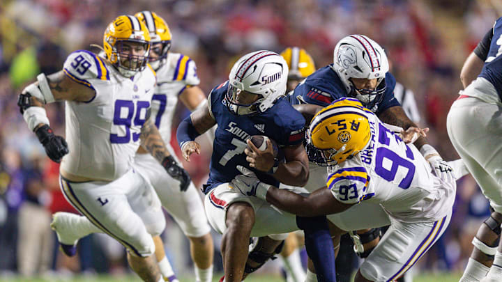 Sep 28, 2024; Baton Rouge, Louisiana, USA;  South Alabama Jaguars quarterback Gio Lopez (7) is sacked by LSU Tigers defensive tackle Ahmad Breaux (93) during the second quarter at Tiger Stadium. 