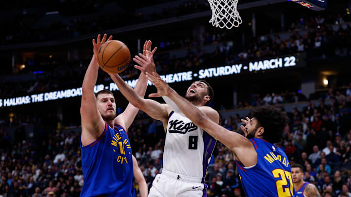 Mar 5, 2025; Denver, Colorado, USA; Sacramento Kings guard Zach LaVine (8) battles for a rebound with Denver Nuggets center Nikola Jokic (15) and guard Jamal Murray (27) in the third quarter at Ball Arena. Mandatory Credit: Isaiah J. Downing-Imagn Images