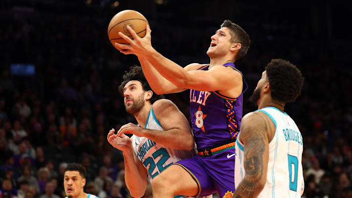 Jan 12, 2025; Phoenix, Arizona, USA; Phoenix Suns guard Grayson Allen (8) shoots the ball against Charlotte Hornets forward Miles Bridges (0) and guard Vasilije Micic (22) during the first half at Footprint Center. Mandatory Credit: Mark J. Rebilas-Imagn Images
