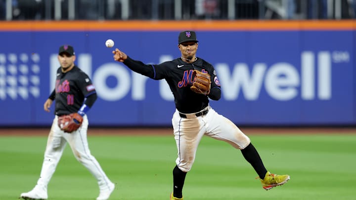 Sep 6, 2024; New York City, New York, USA; New York Mets shortstop Francisco Lindor (12) throws out Cincinnati Reds third baseman Santiago Espinal (not pictured) to end the top of the tenth inning at Citi Field. Mandatory Credit: Brad Penner-Imagn Images